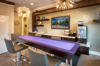 a dining room with a purple table and chairs